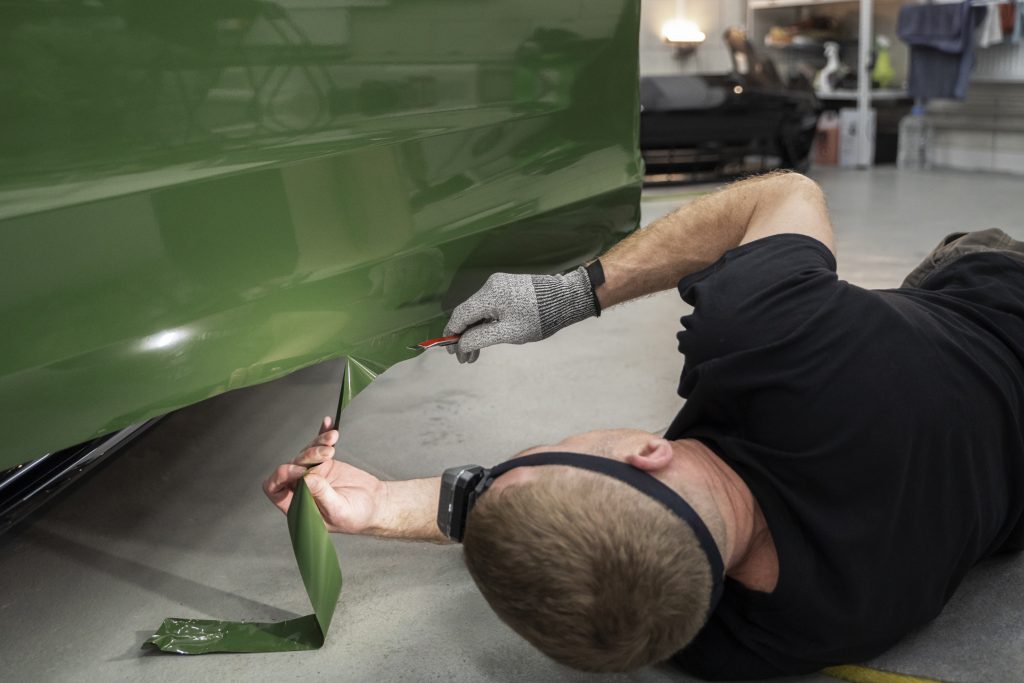 10 Most Common Vehicle Vinyl Wrap Mistakes and How to Avoid Them person working car wrapping